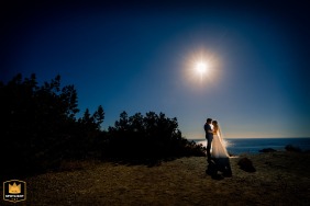 Love on the Mediterranean: A bride and groom's romantic portrait on the island of Ibiza On the idyllic island of Ibiza, a bride and groom pose for a picturesque photo shoot against a bold blue sky and under the scorching sun.